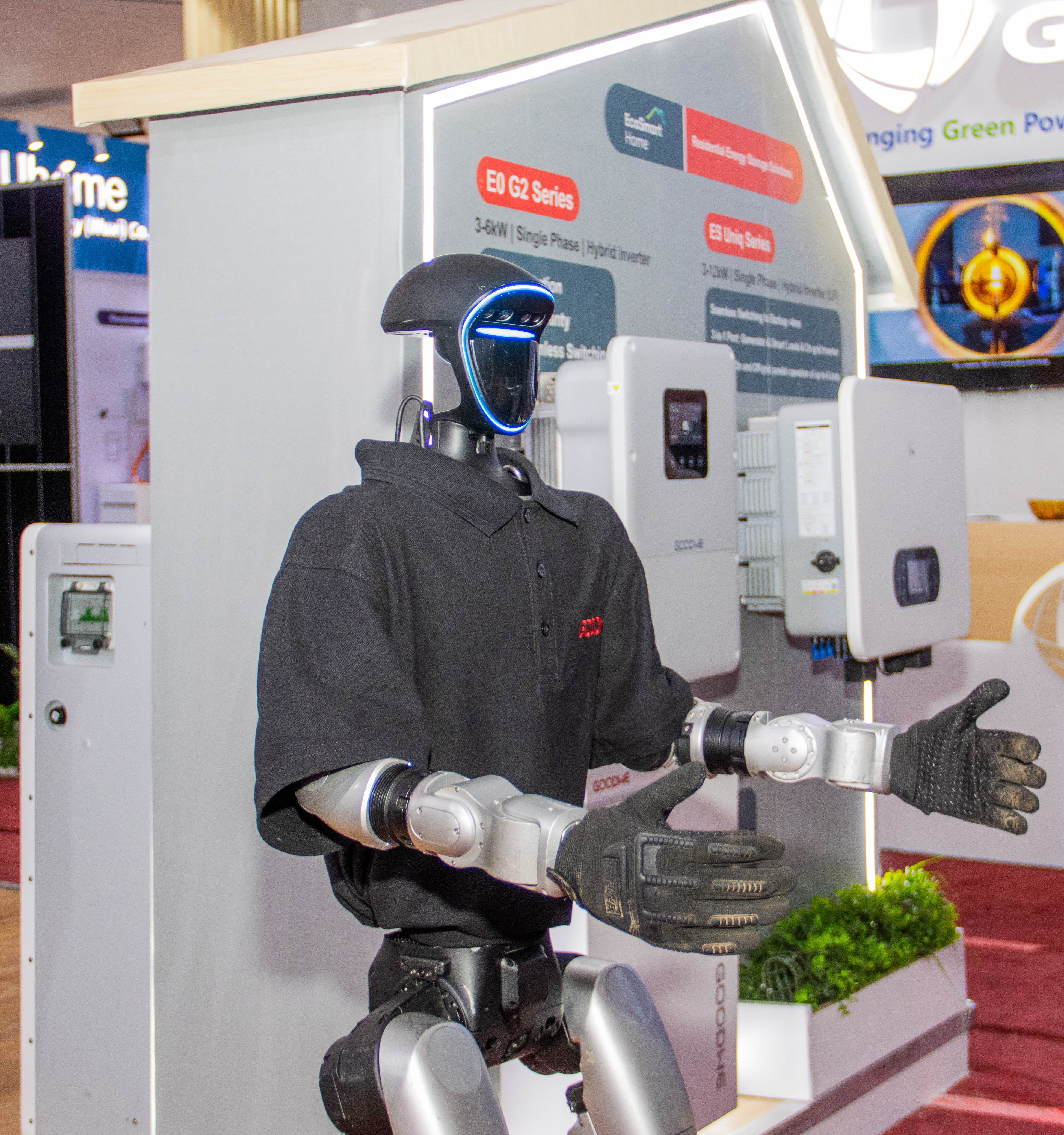 A humanoid robot with a glowing face gestures with open hands
